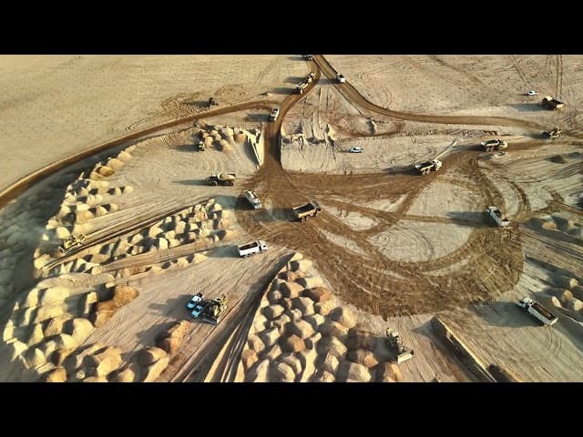 Drone view of a large construction site with heavy machinery and partially completed buildings in Riyadh